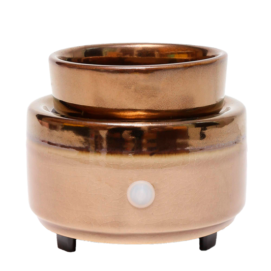Copper-colored electric warmer on a white background